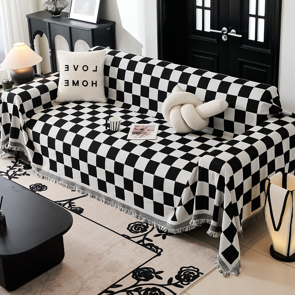 Sloane black checkerboard fringe throw over a sofa