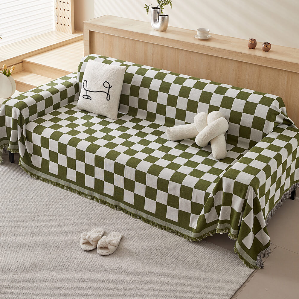 Sloane green checkerboard fringe throw over a sofa