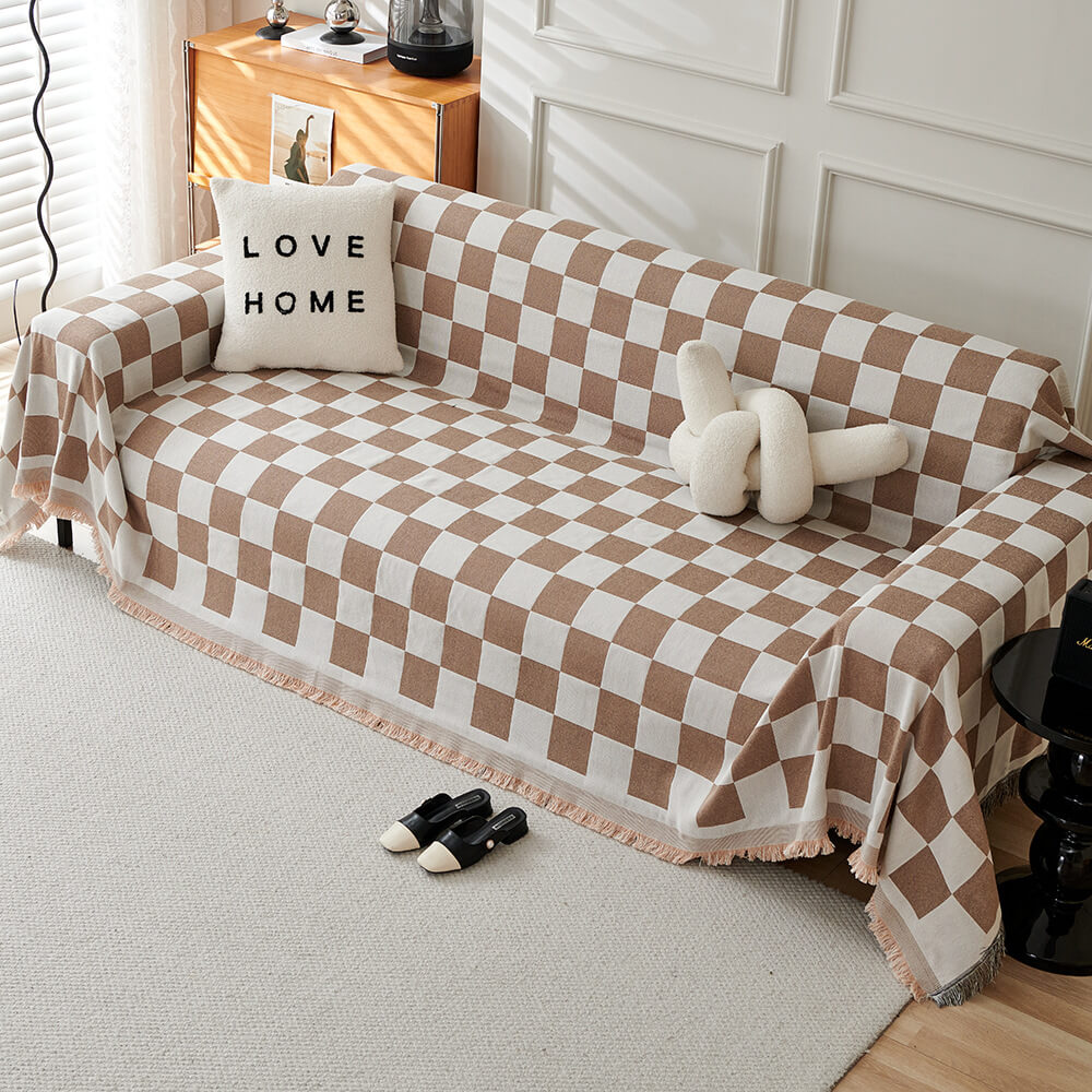 Sloane coffee checkerboard fringe throw over a sofa