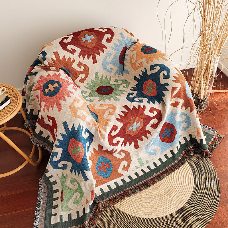 Sloane geometry aztec fringe throw over an armchair
