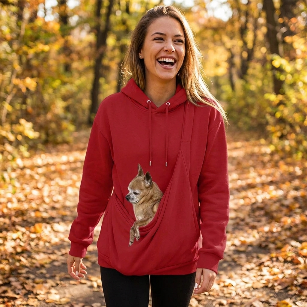 Woman walking outdoors in the Kanga carrier hoodie with her dog in the pouch
