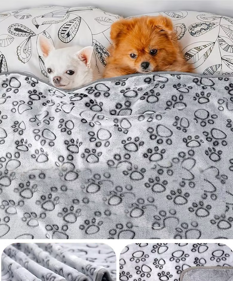 Two dogs snuggled under the Cuddle gray paw-print dog blanket