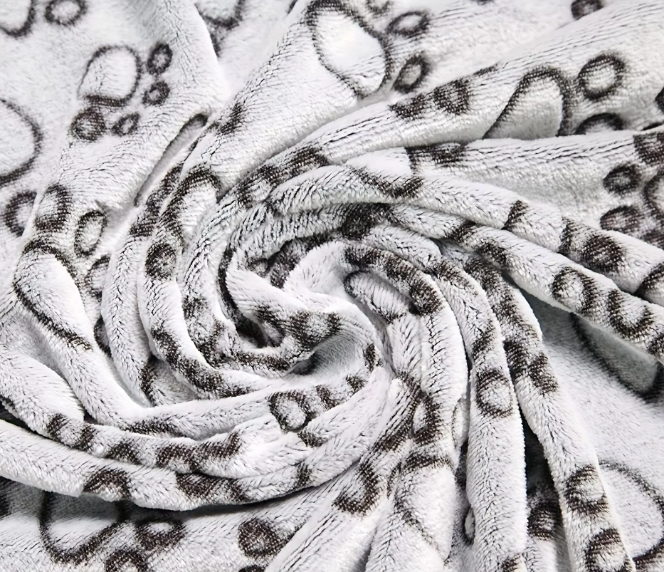 Close-up of the Cuddle gray paw-print fleece texture