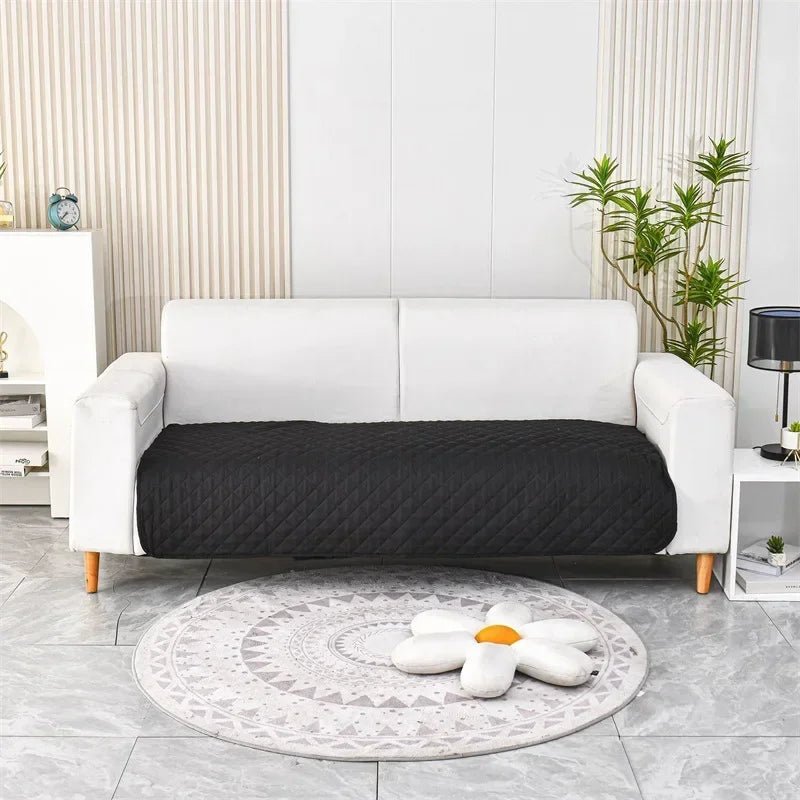 Otter Waterproof Dog Blanket – Black quilted protector on a sofa
