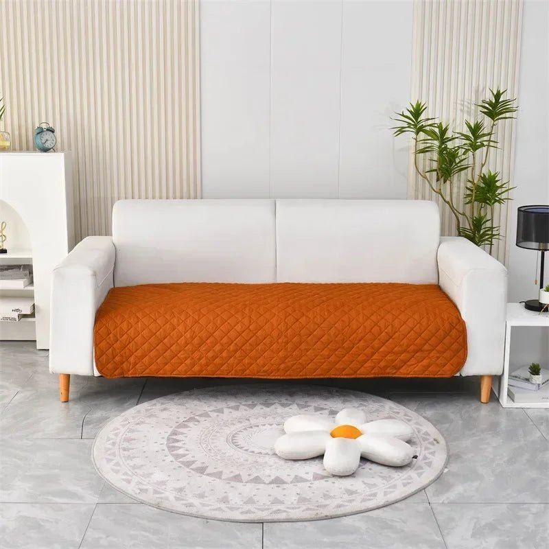Otter Waterproof Dog Blanket – Orange quilted protector on a sofa