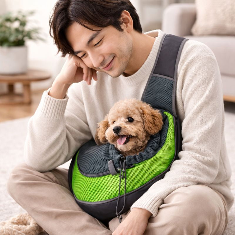 Man holding his poodle in the green Ranger dog sling carrier