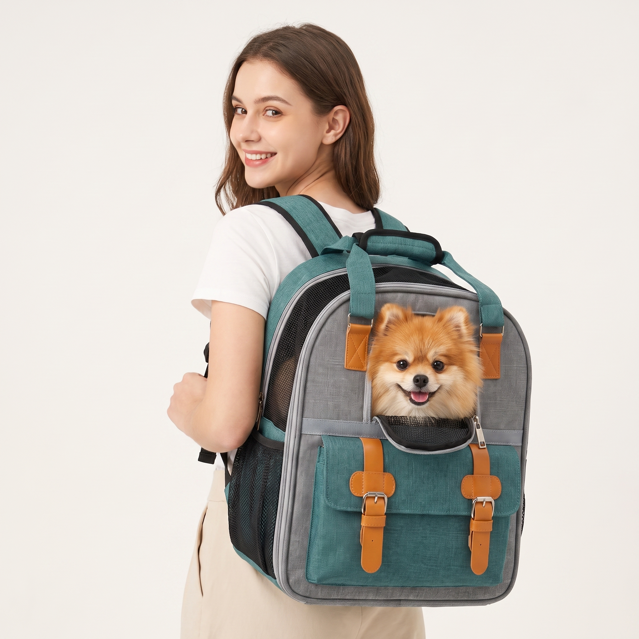 Woman wearing the teal Scout dog carrier backpack with a happy Pomeranian peeking through the mesh