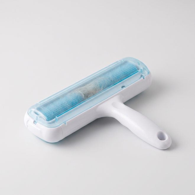 Fuzz reusable dog hair remover with a white handle and translucent blue roller on a clean surface