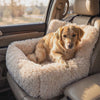 Golden retriever settling in to rest inside the Nuzzinel Burrow plush car bed on a calm drive