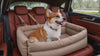 A dog riding in the Nomad Dog Car Booster Seat looking out the window