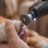 Gently grinding the tip of a dog's nail with the Buff cordless dog nail grinder
