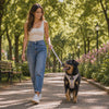 Owner walking a dog wearing the Rowan plaid harness and leash on a sunny path