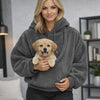 Woman carrying her puppy in the Joey wearable dog carrier hoodie pouch