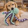 Golden retriever playfully shaking the Ollie plush octopus dog toy