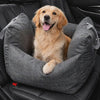 Golden retriever settling into the charcoal-grey Roam Waterproof Dog Car Seat Bed on a car ride