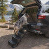 Boost Foldable Dog Car Stairs — a dog calmly climbing the five non-slip steps into an SUV