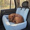 Dog relaxing in the light blue Nuzzinel Breeze cooling car bed during a sunny car ride