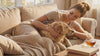 Woman wearing the rose quartz dog paw print bracelet while petting her dog