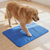 Dog settling down onto the Polar blue gel dog cooling mat to cool off