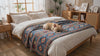 French Bulldog settling on a blue Moroccan jacquard dog throw