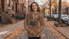 Woman wearing the Rhodesian Ridgeback big face hoodie on an autumn street