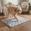 Dog settling down to nap on the grey star Doze plush dog bed mat