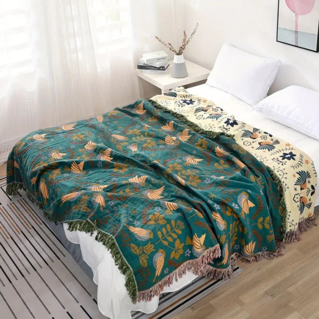 Wren Scandinavian Bird Throw – teal bird throw styled across a bed