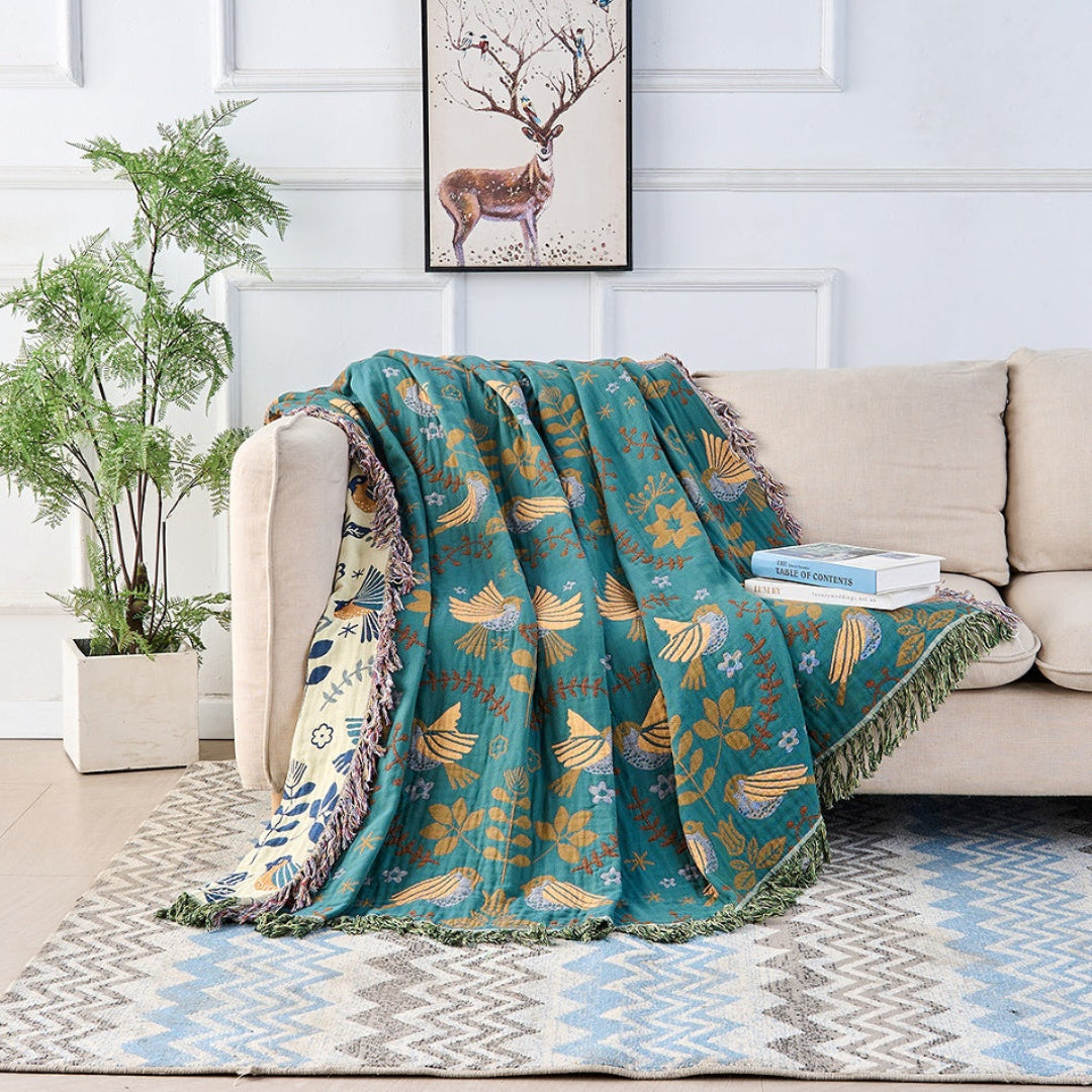 Wren Scandinavian Bird Throw – throw draped over a sofa showing the cream reverse