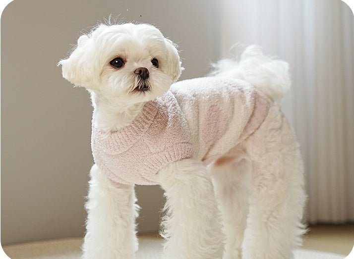 Pink fleece dog sweater with ruffled collar on a small dog