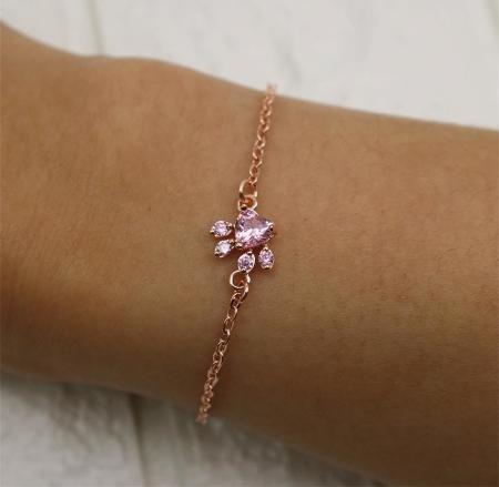 Rose quartz paw print bracelet worn on the wrist